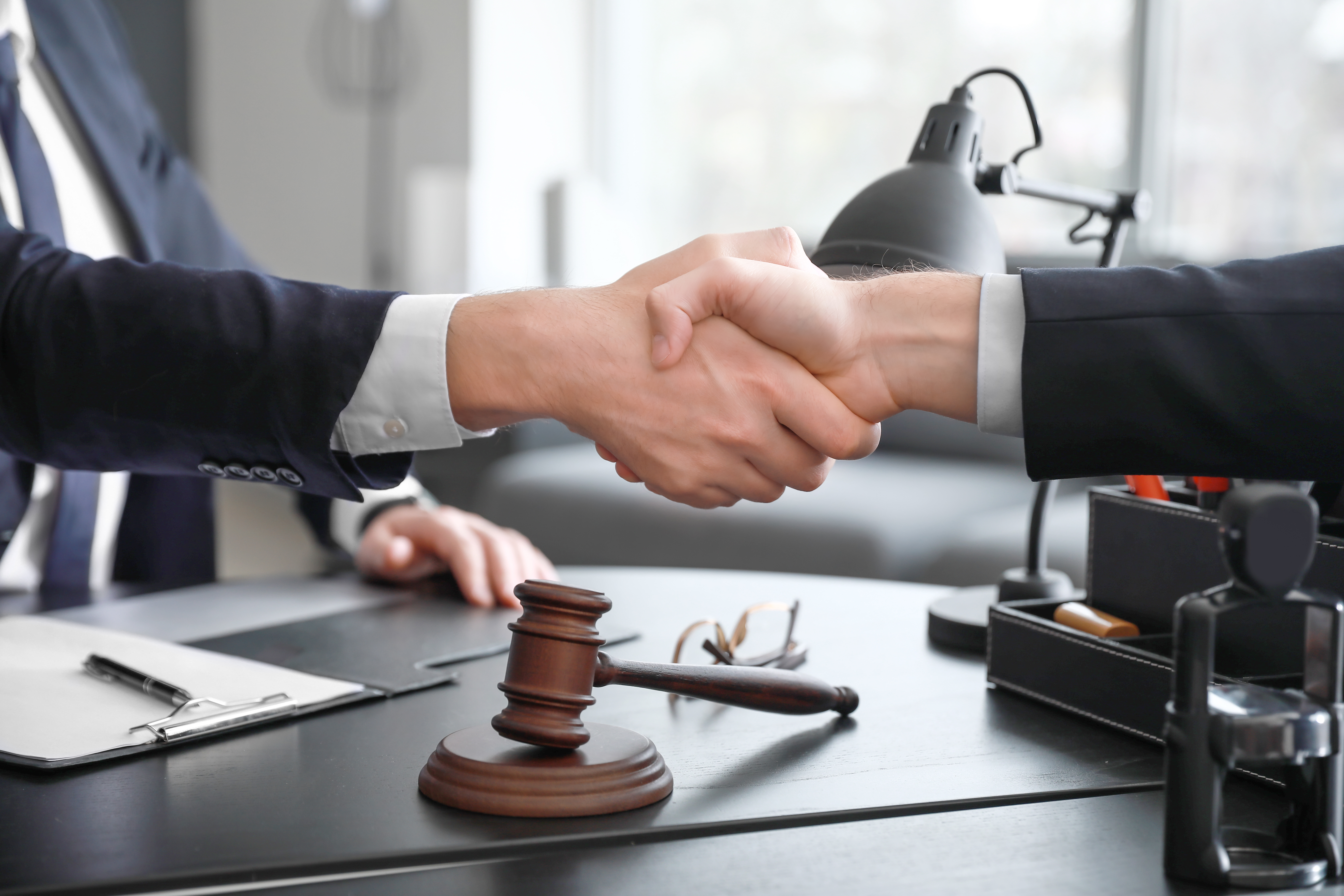 Attorney shaking hands with client